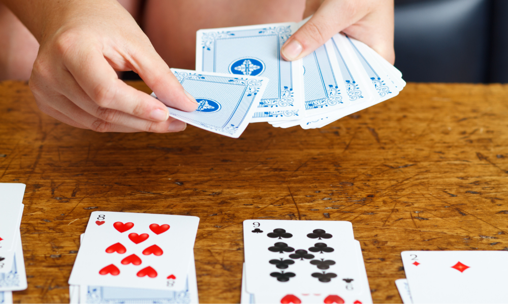 Focused player deep in thought, deciding the next move in a game of solitaire.